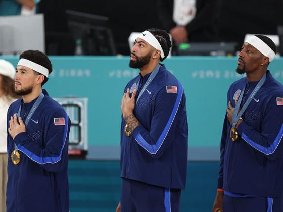 Three former UK Men's Basketball Players Standing on the Podium Receiving Gold Medals